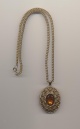 Vintage Avon solid perfume locket pendant convertible to pin with glass cabochon imitating amber, 1970's, length chain 18'' 46cm., pendant 2'' 6cm.