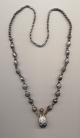 Necklace with metal perfume bottle pendant and metal beads, India, length necklace 27'' 70cm., bottle 1.5'' 4cm.
