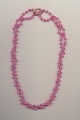 A twisted double strand bead necklace made of one necklace and a pearl shortener