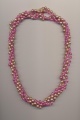 A twisted four strand bead necklace made of two necklaces and a pearl shortener