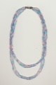A twisted bead necklace made of strands of uneven length