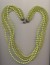 Vintage multi strand plastic imitation bead necklace made in different hues of green, with clasp, 1960's, length 25'' 64cm.